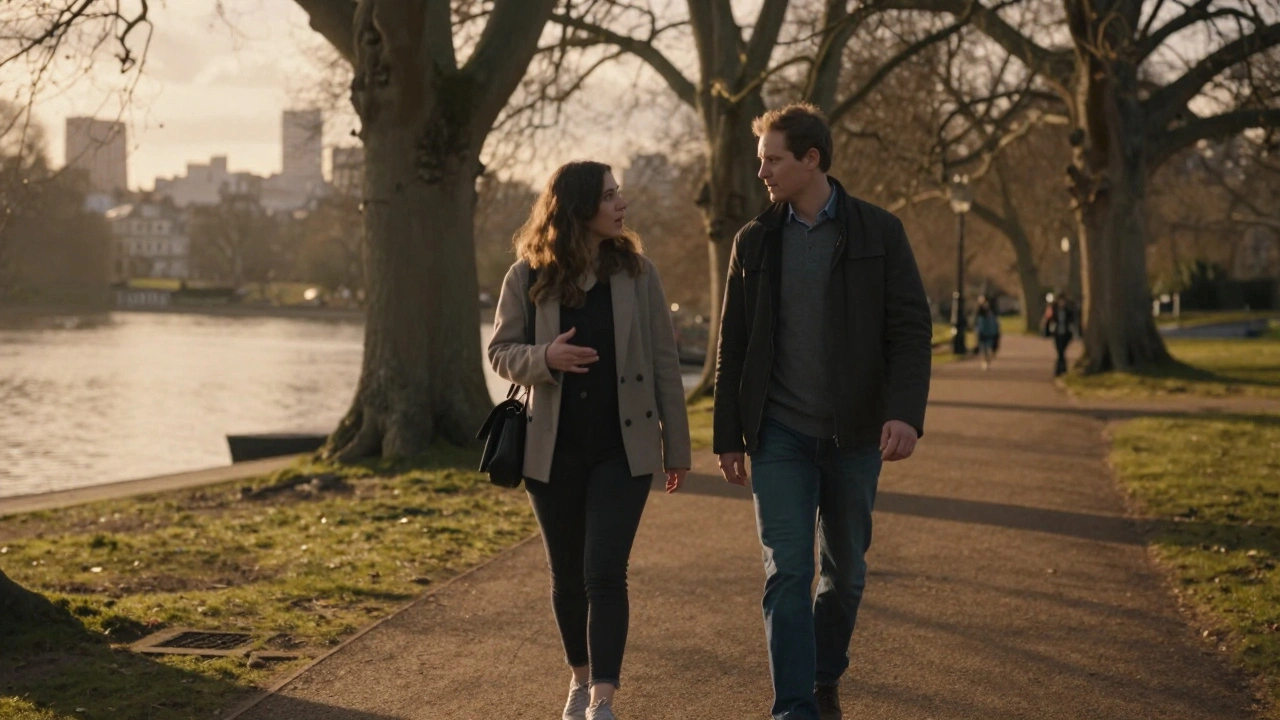A couple walking peacefully through Hyde Park at sunset, lost in conversation.