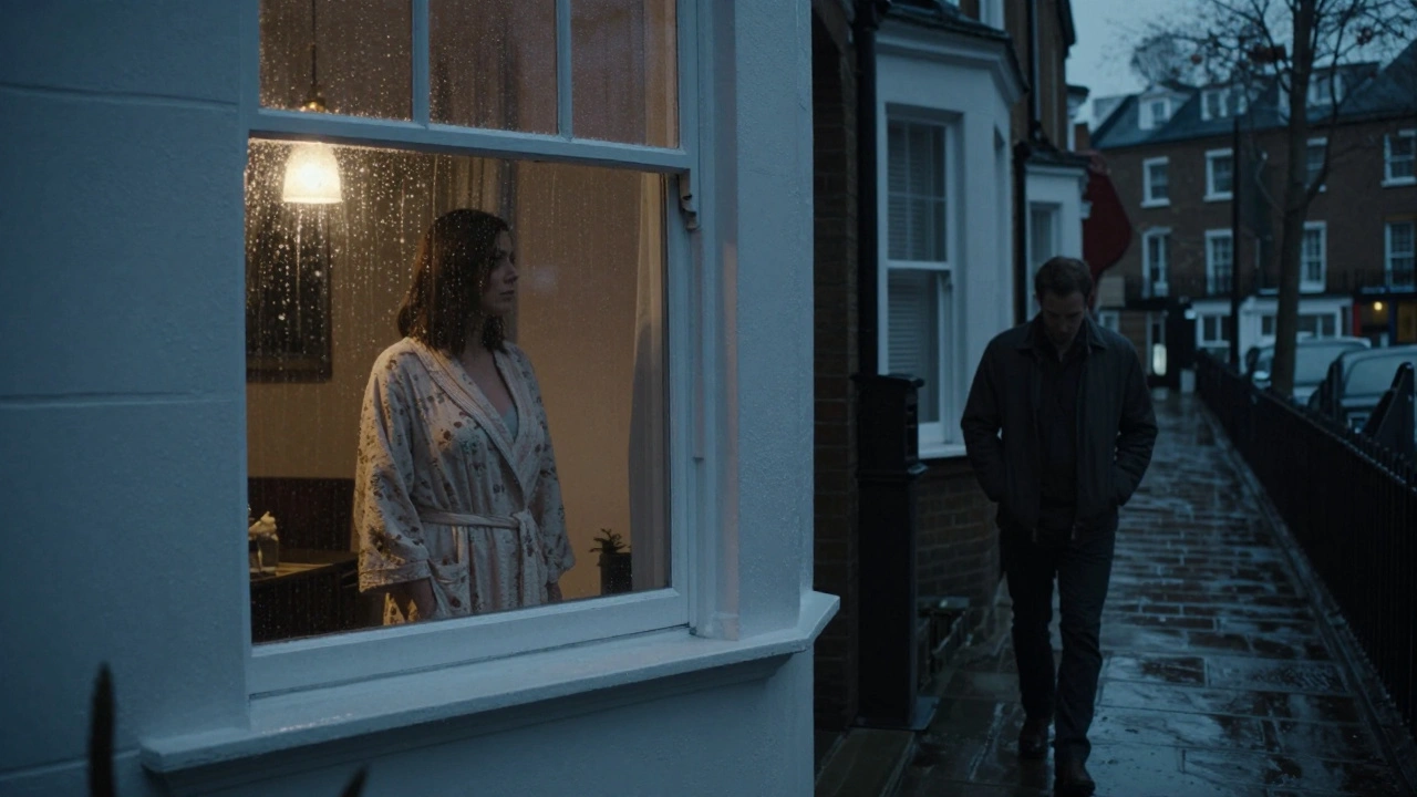 A woman at a window in a North London flat as a client walks away under rainy night lights.